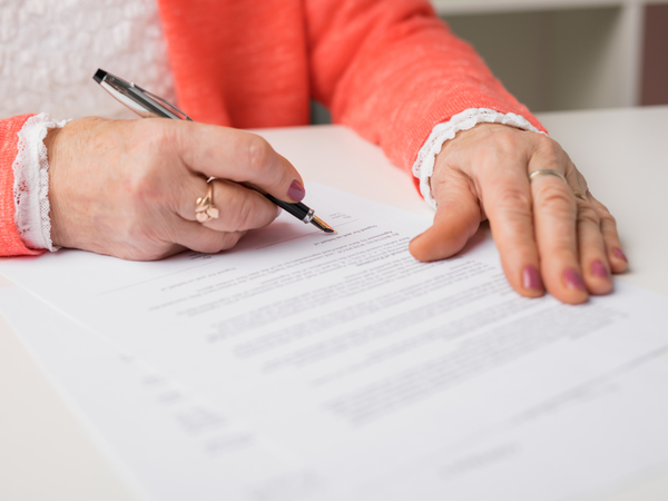 Old lady signing document