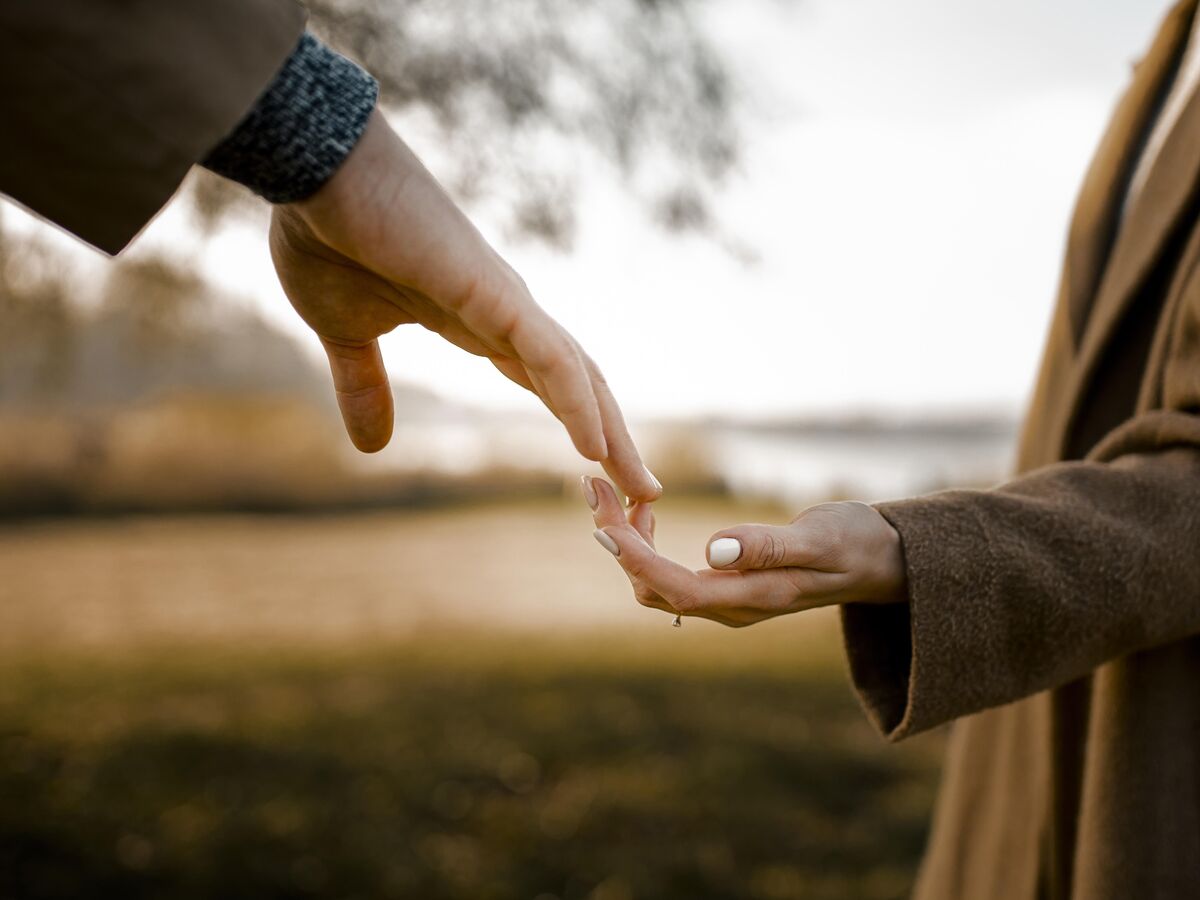Close up couple holding hands outdoors