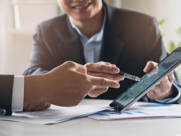 man showing person ipad
