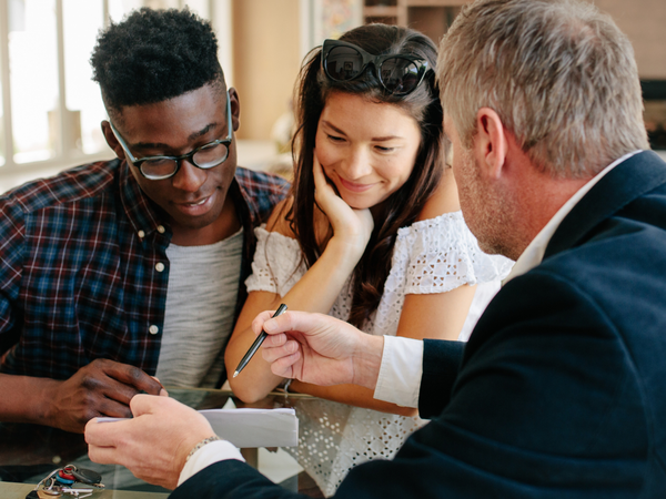 couple speaking to man